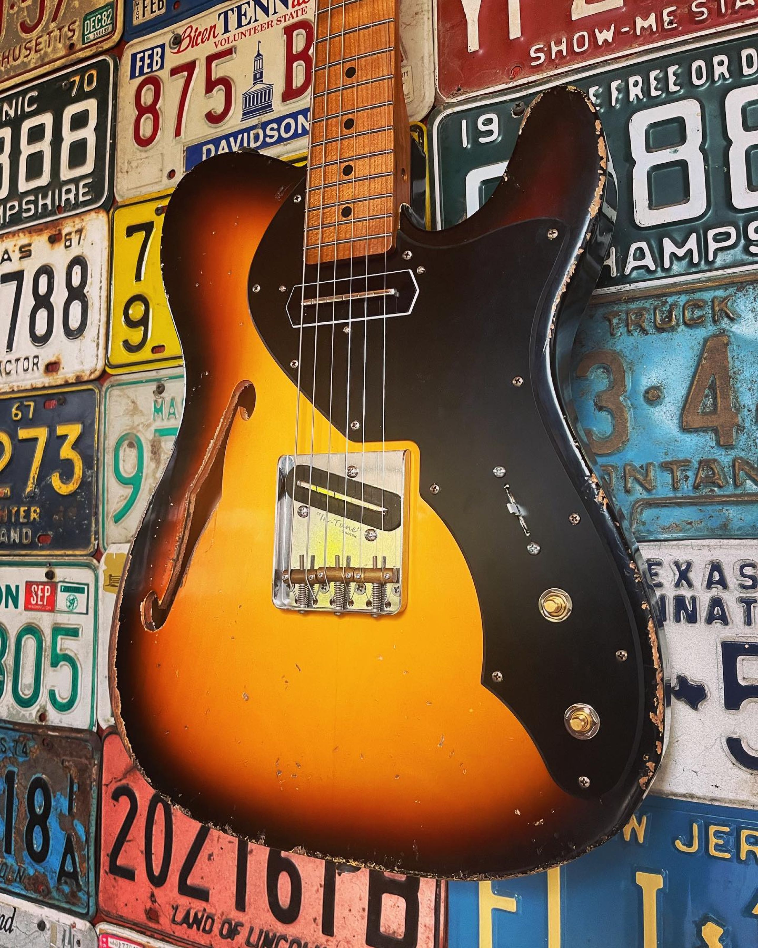 Seth Lee Jones Guitars - workshop hanging sunburst guitar.