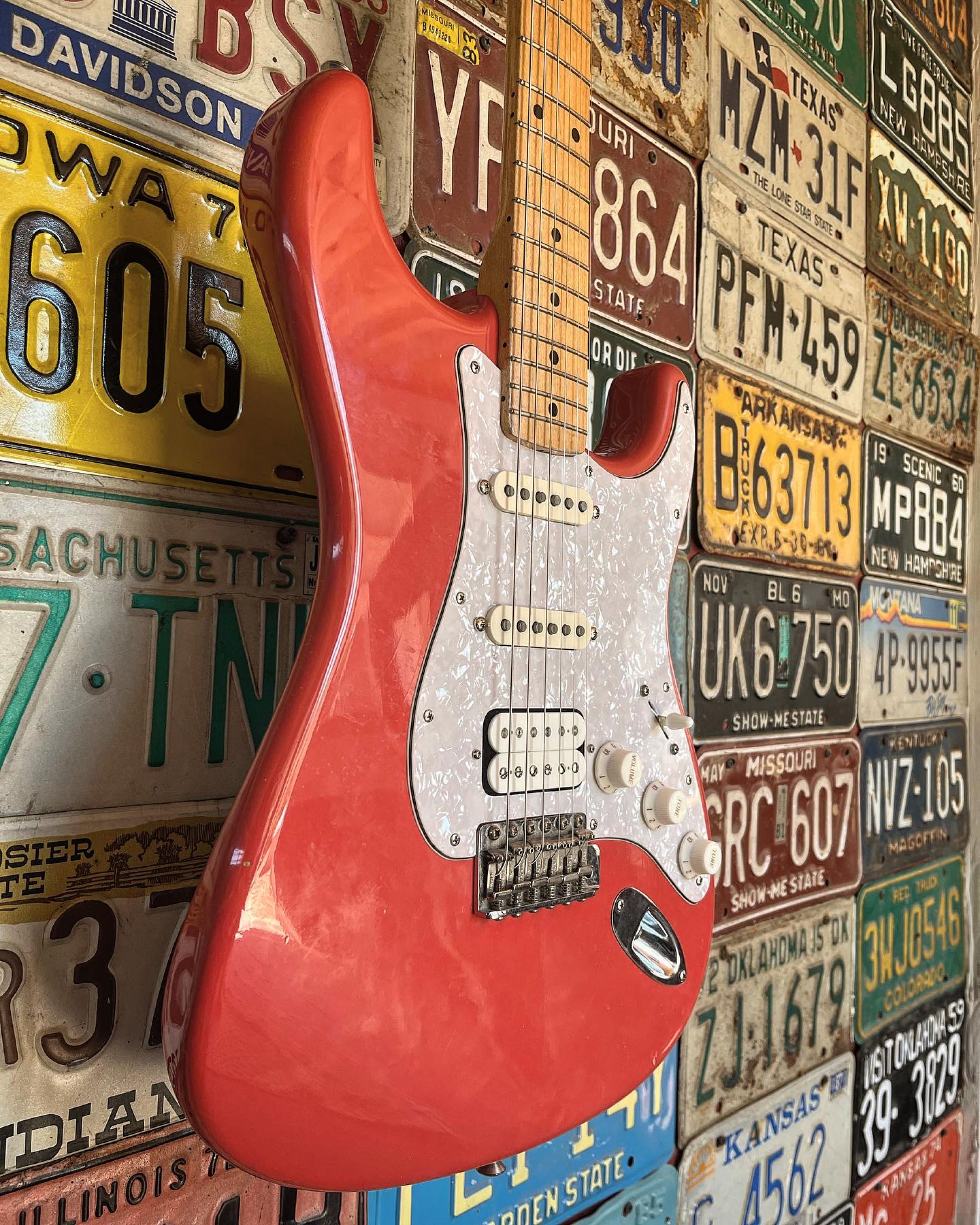 Seth Lee Jones Guitars - workshop hanging red guitar.